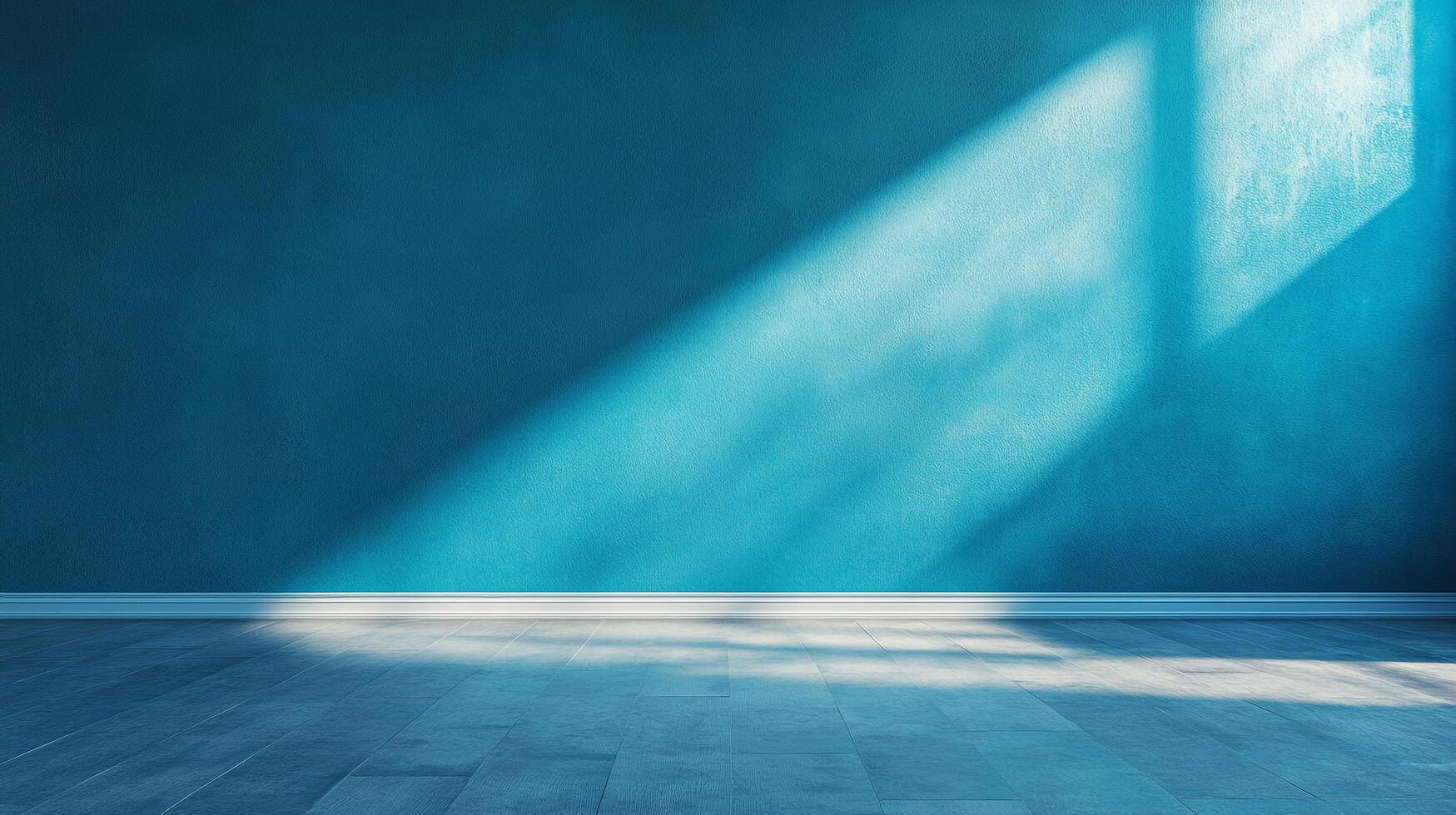 An interior setting features a captivating interplay of light and shadows on a teal wall, complemented by a wooden floor. photo
