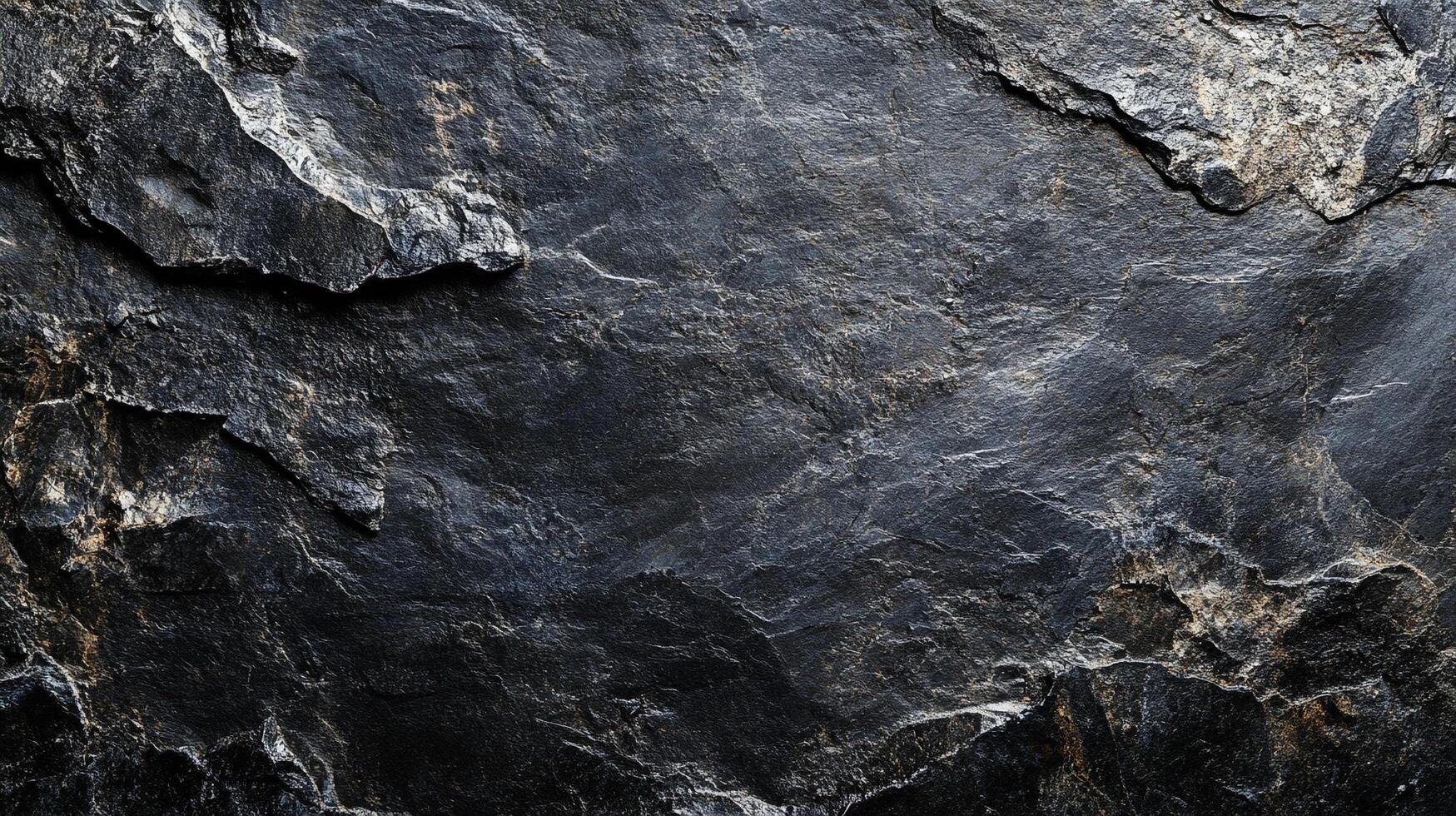 Detailed view of a dark, textured rock face. The rough surface highlights the natural patterns and age of the stone formation. photo