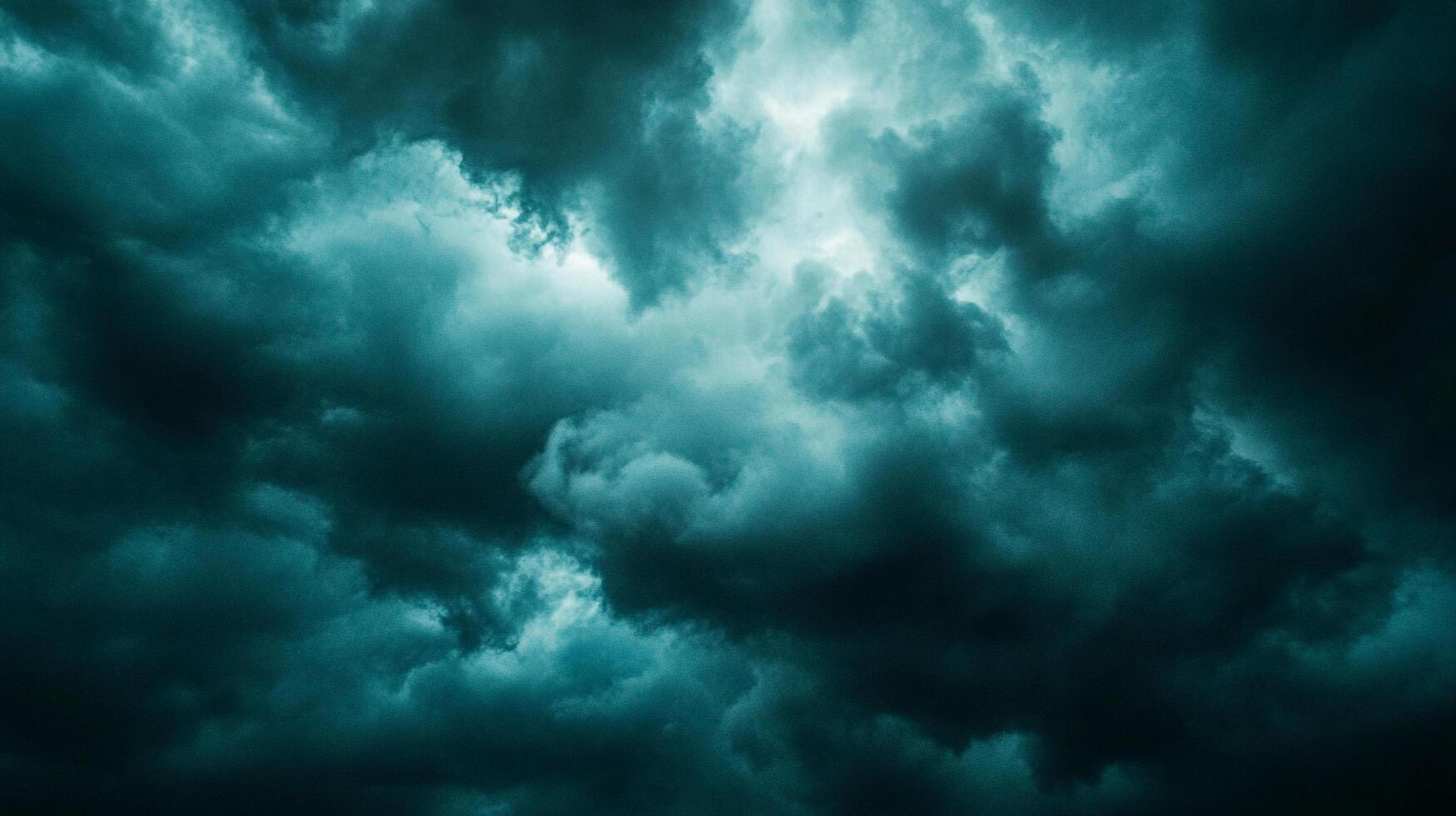 An eerie sky view filled with dark clouds. A storm approaches, the dramatic sky is filled with menacing weather and vibrant turquoise. photo