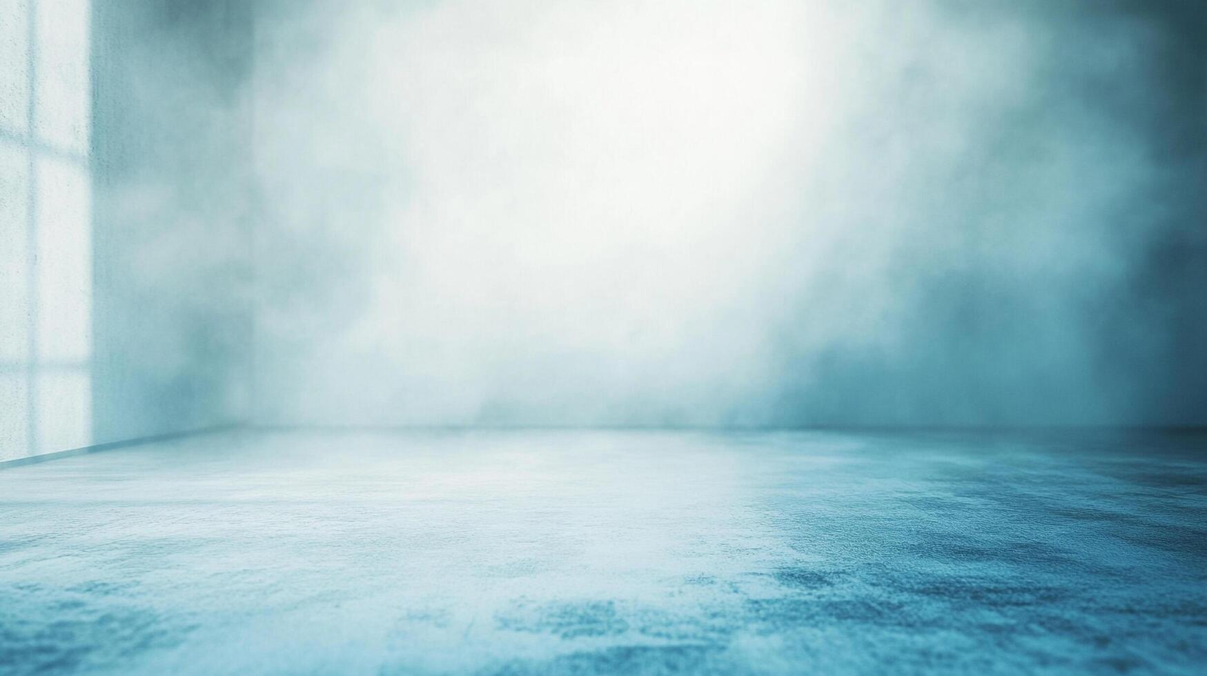 An empty, bluish-grey room with a window casting light on the left wall, filled with haze or fog. A minimal and atmospheric scene. photo