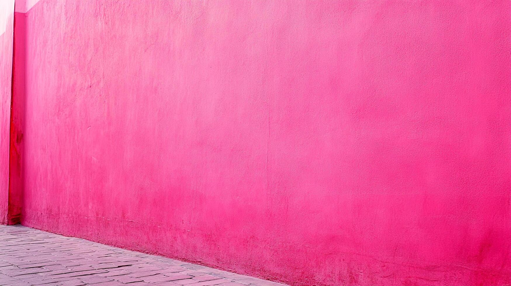 Vibrant pink wall stands tall beside a stone path, creating a bold and captivating street scene with a touch of urban charm. photo