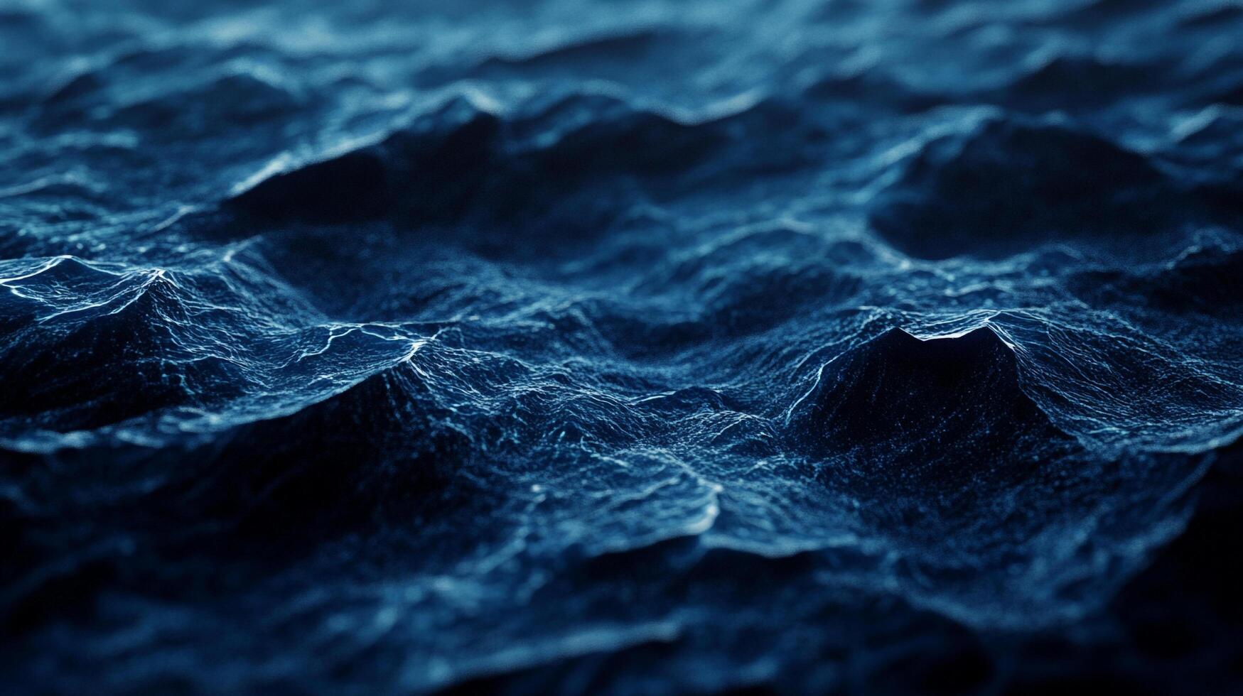 Waves ripple across the dark blue water, creating intricate patterns and textures. The ocean's surface is a mesmerizing display of nature's beauty. photo
