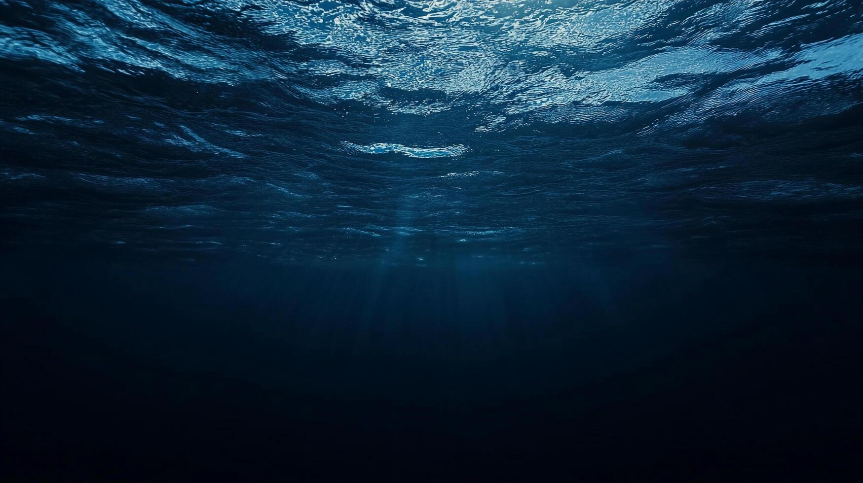 Underwater view capturing the serene dance of light filtering through the ocean surface, creating an ethereal ambiance of deep blue tranquility. photo