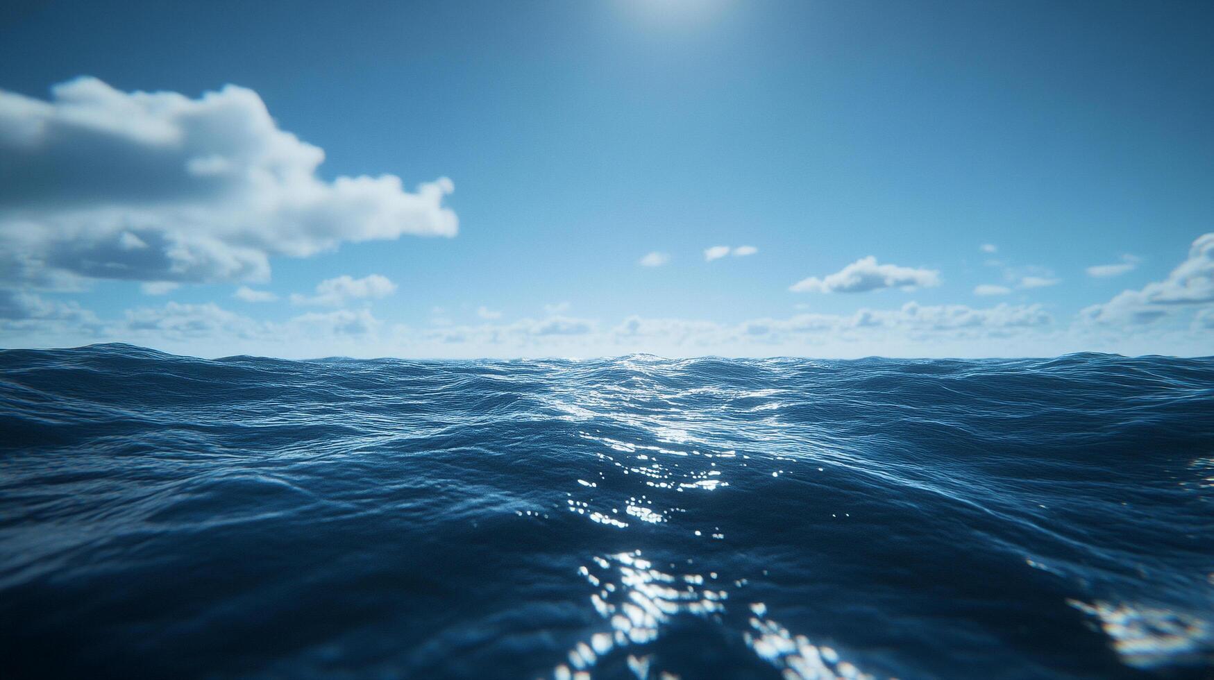 Ocean view under a bright blue sky with scattered white clouds, showcasing the vastness and serenity of the open sea. photo