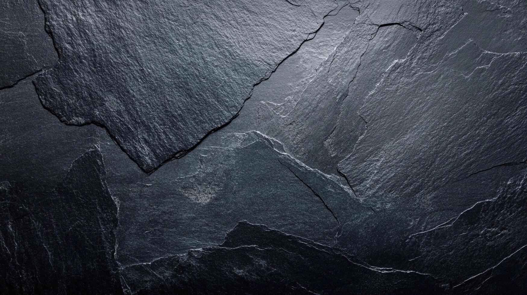 Dark slate texture displaying layered rock formations. A rugged, natural surface with deep gray and black tones, showcasing raw material. photo