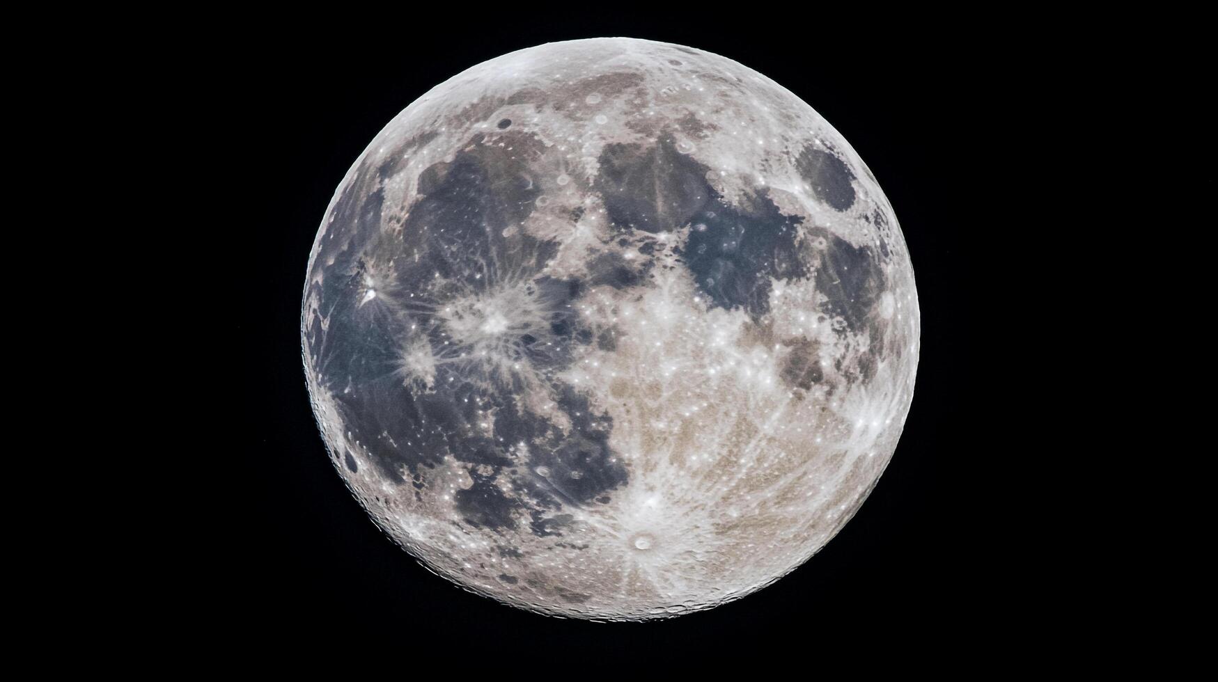 The moon is captured in stunning detail against a black backdrop, revealing its craters, textures, and ethereal beauty. Celestial sphere. photo
