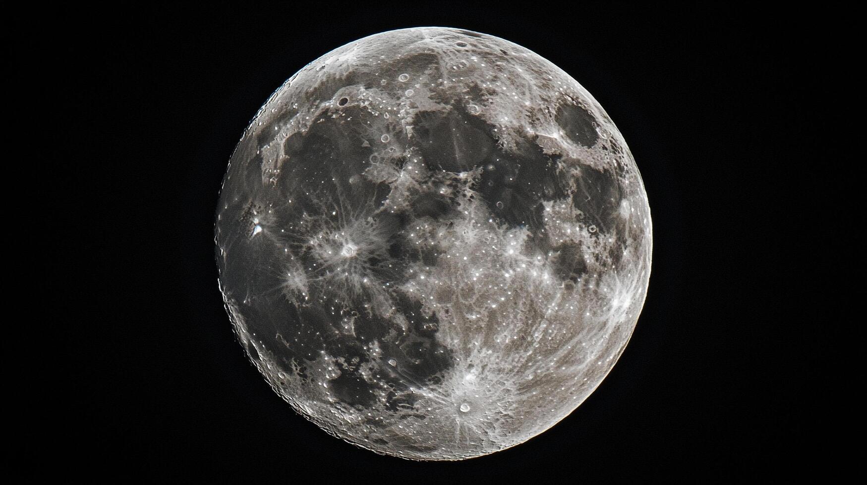Detailed shot of the moon, showcasing its craters and textures against the inky blackness of space. photo
