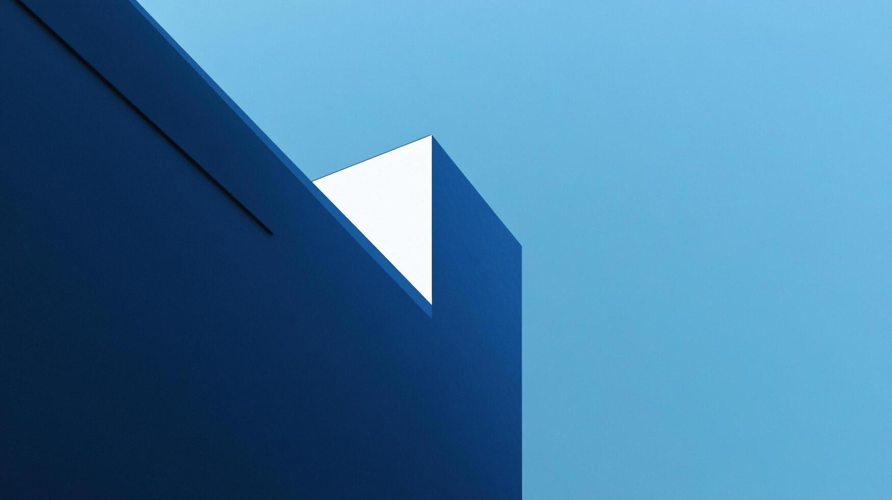 A striking image of geometric blue architecture set against a bright blue sky, highlighting the contrast between structured design and the expanse of nature. photo