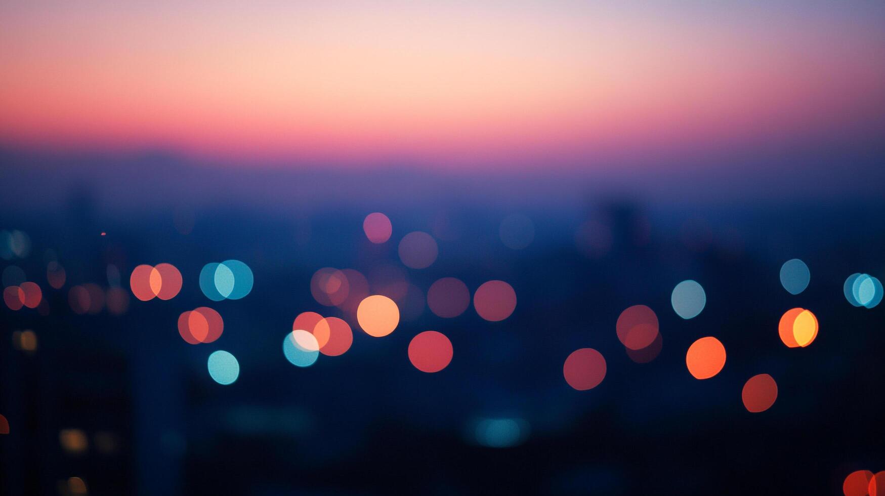 Blurred cityscape view featuring city lights at dusk, capturing the vibrant skyline colors of pink and orange against the dark background. photo