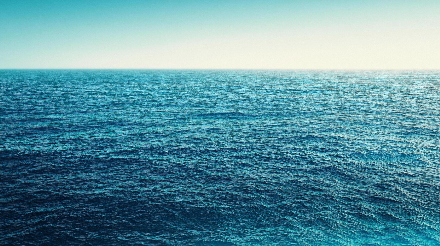 Vast expanse of the ocean meeting a clear horizon. Calm waters reflect the bright sky, showcasing a tranquil oceanic scene. photo