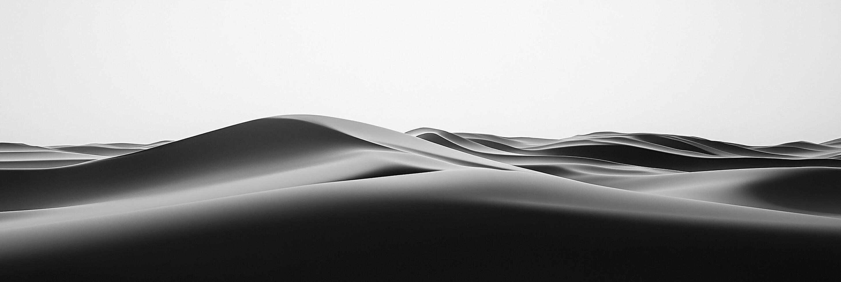 Monochromatic landscape of sand dunes, showcasing rolling forms and subtle contrasts. The scene evokes isolation and the beauty of nature. photo