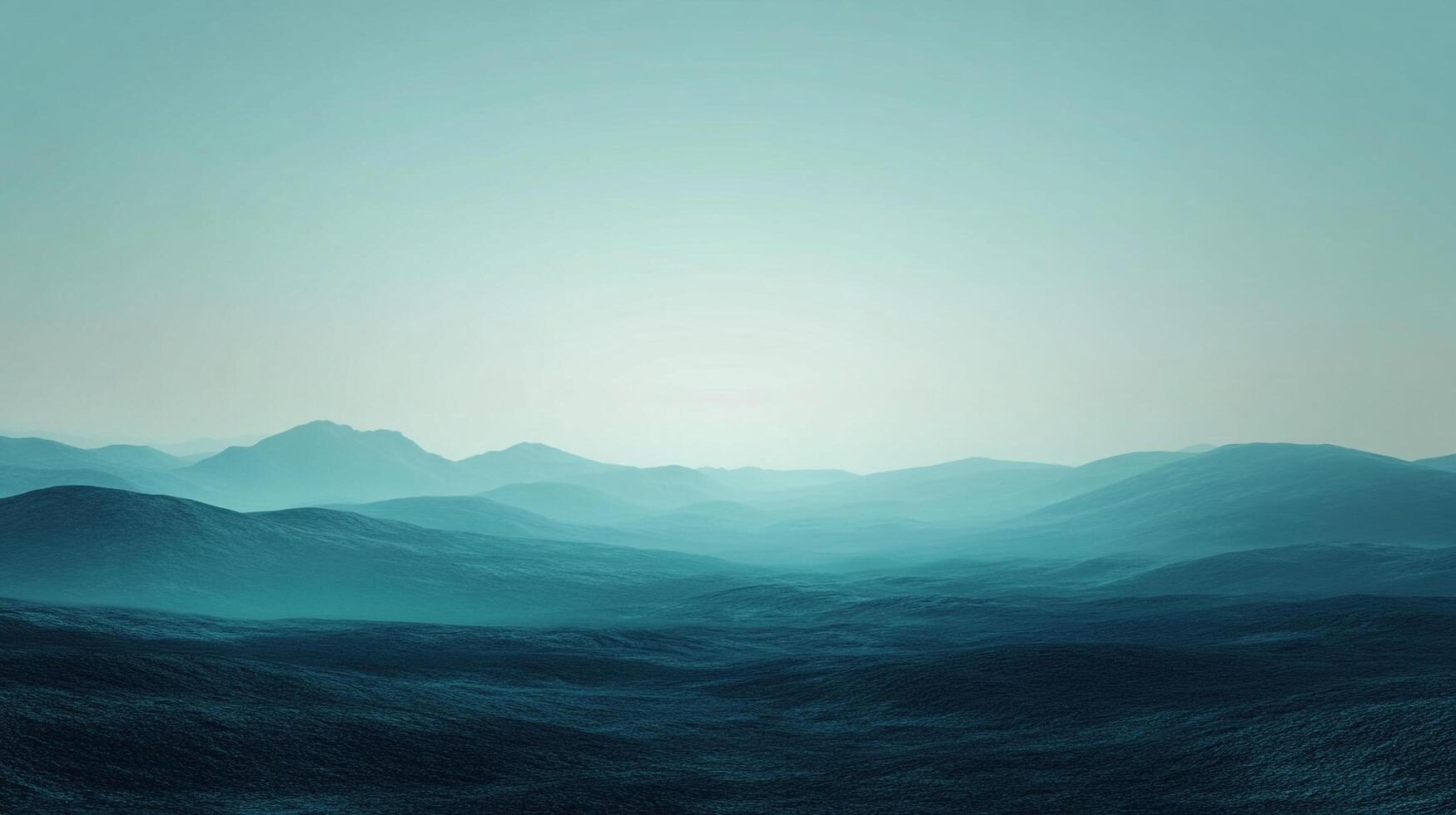 Serene teal waves meet the horizon beneath a pale blue sky. Misty mountains add depth to this calming, tranquil seascape. photo