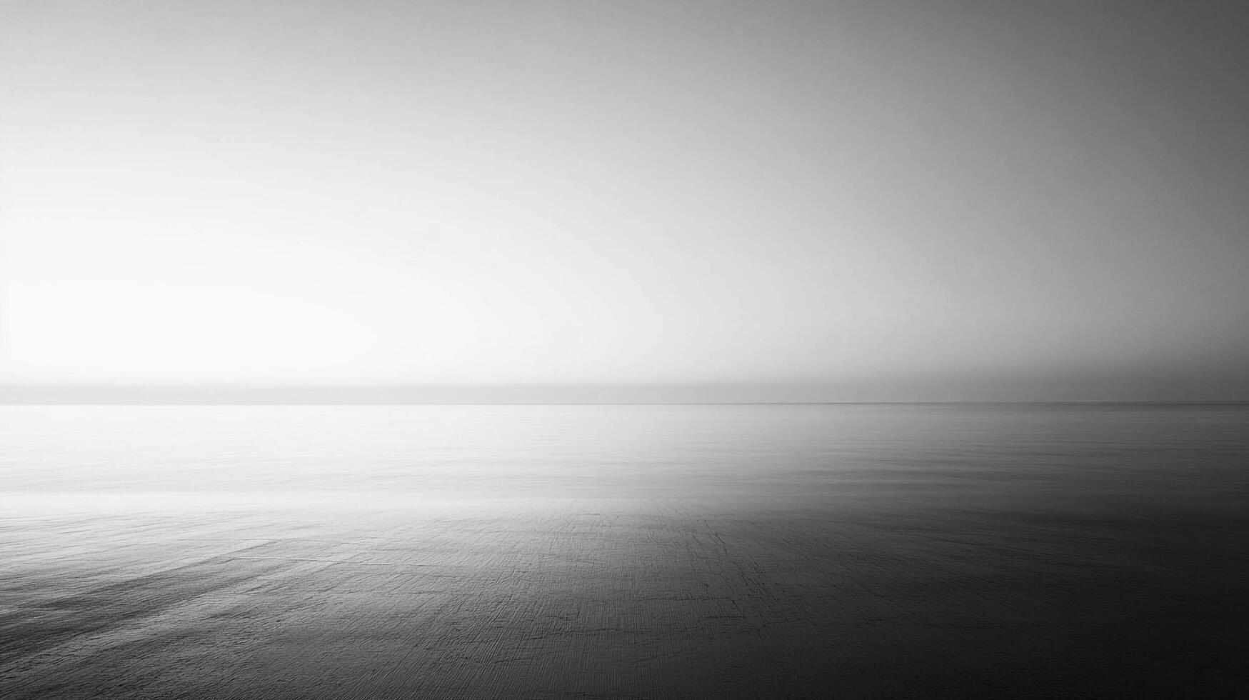 A grayscale, serene seascape featuring a tranquil horizon, seamlessly blending water and sky in a minimalist monochrome palette. Peaceful and calm. photo