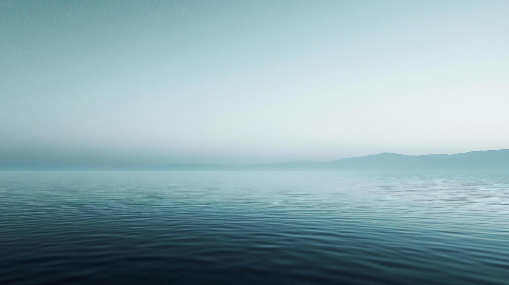 Calm ocean surface at the horizon, minimalist landscape with serene water reflecting the soft light, mountains faintly in the distance. photo