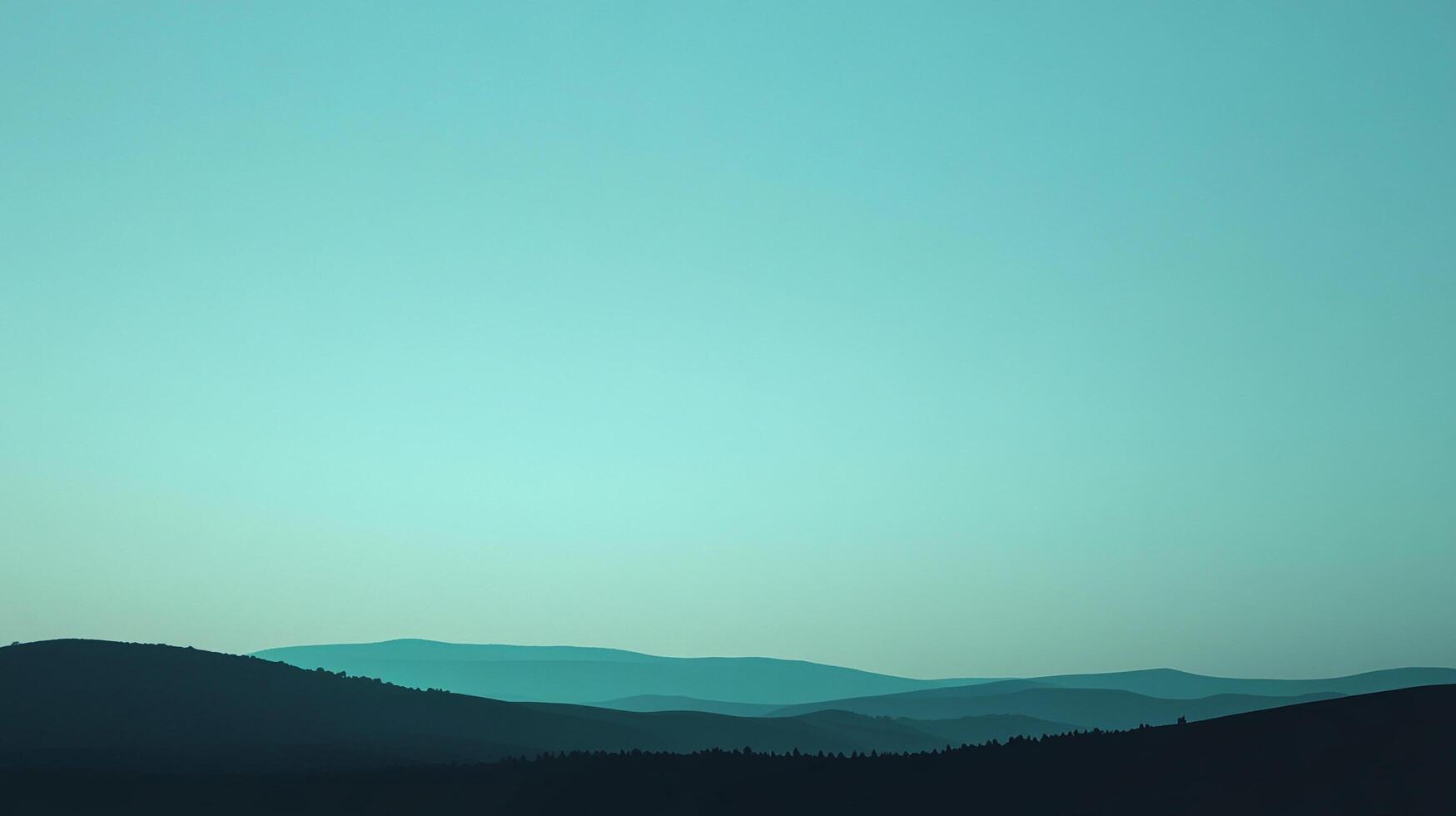 Silhouette of rolling hills under an expansive teal sky. A gradient of color creates a serene and peaceful atmosphere. Nature's beauty is displayed. photo