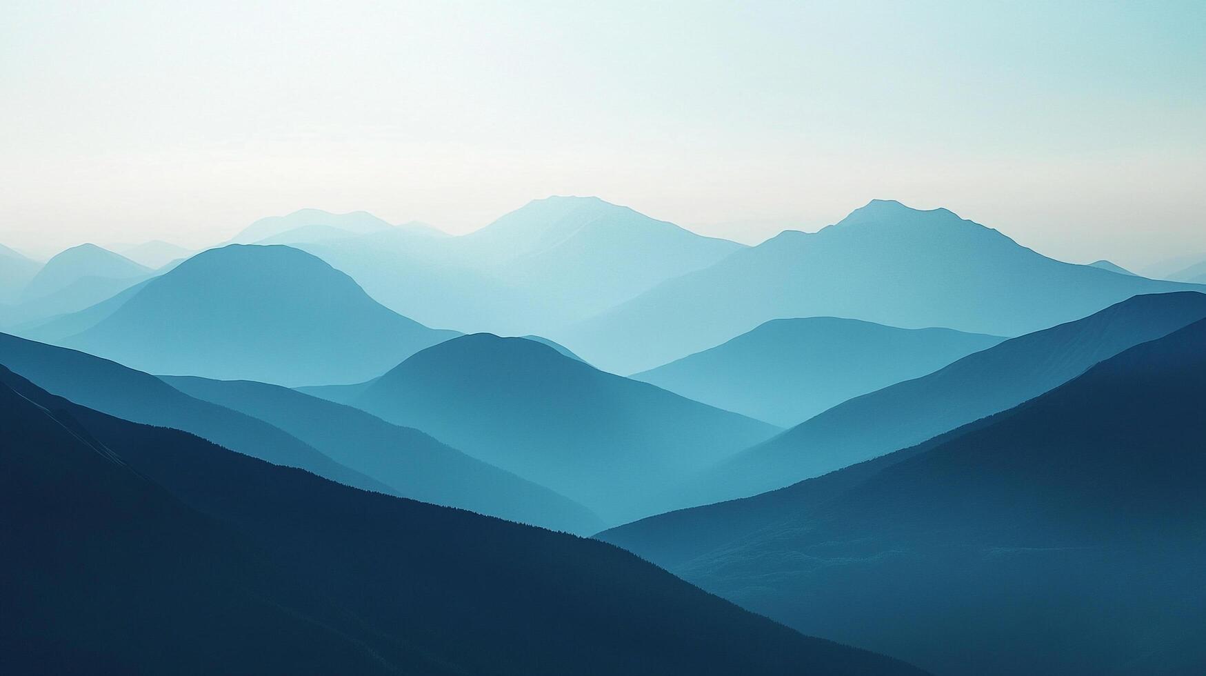 An expansive vista reveals layers of serene blue mountain ranges, each fading into the distance, evoking tranquility and grandeur. photo