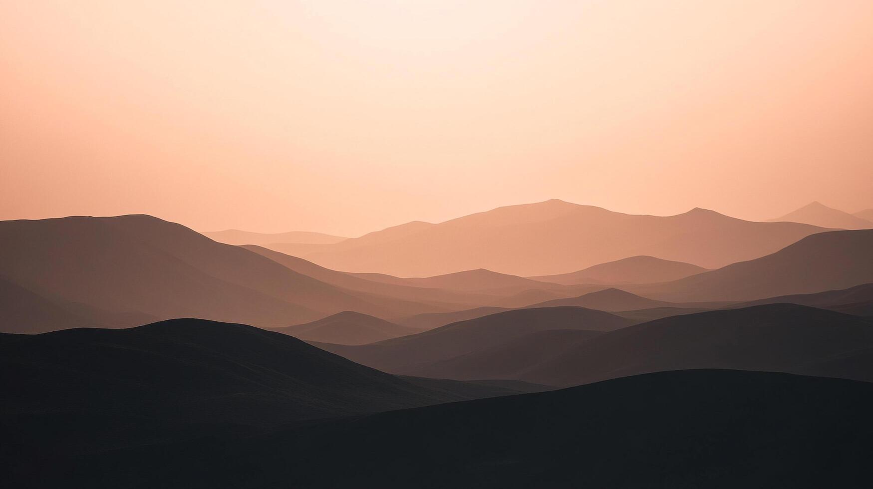Serene mountain ranges layered under a soft, hazy light create a peaceful landscape. The varying shades add depth and beauty. photo