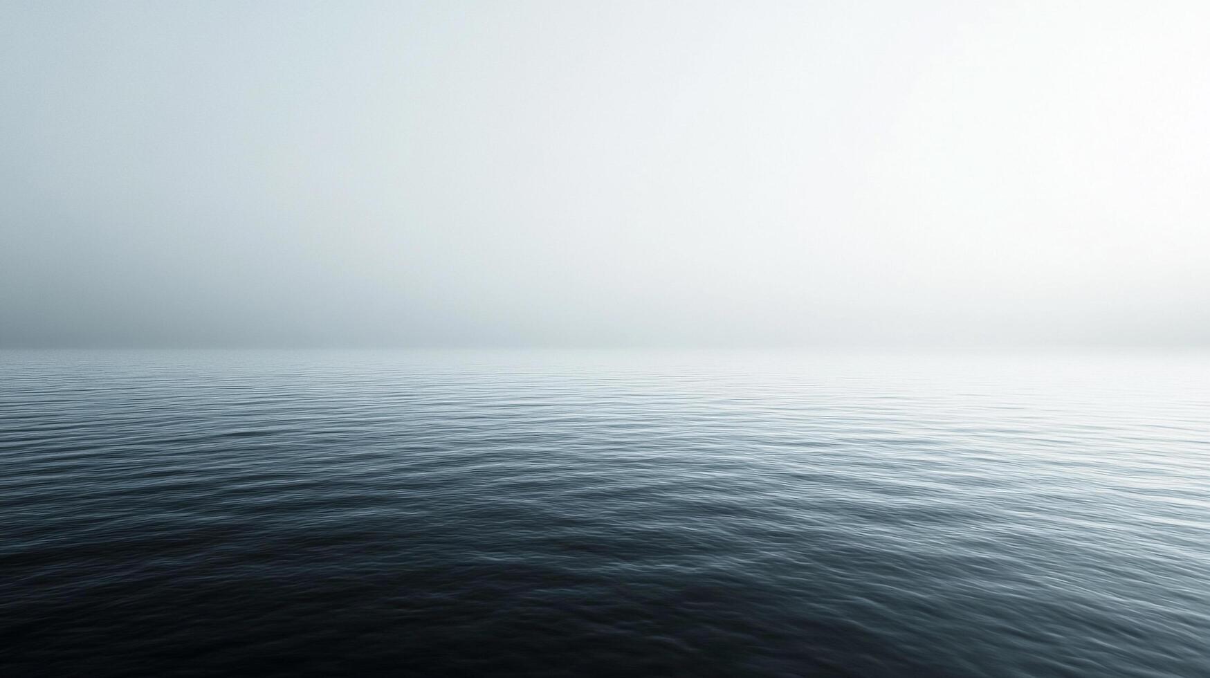 Serene ocean vista with subtle ripples under a misty sky, evoking calm and tranquility. The horizon is barely visible in the soft light. photo