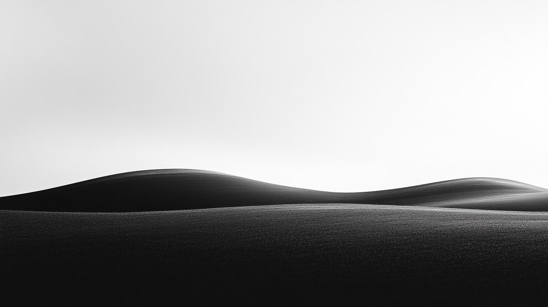 Minimalist landscape of rolling hills in monochrome, showcasing simplicity and tranquil beauty of nature in a serene setting. photo