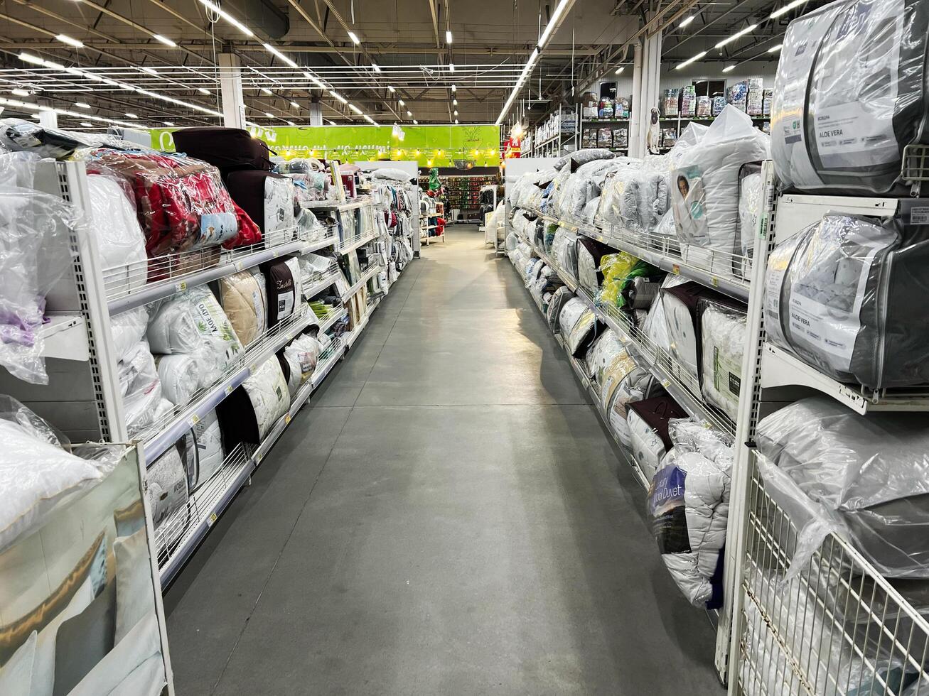 Lviv, Ukraine - February 16, 2025 Warehouse shelves lined with bedding products in a brightly lit retail store photo