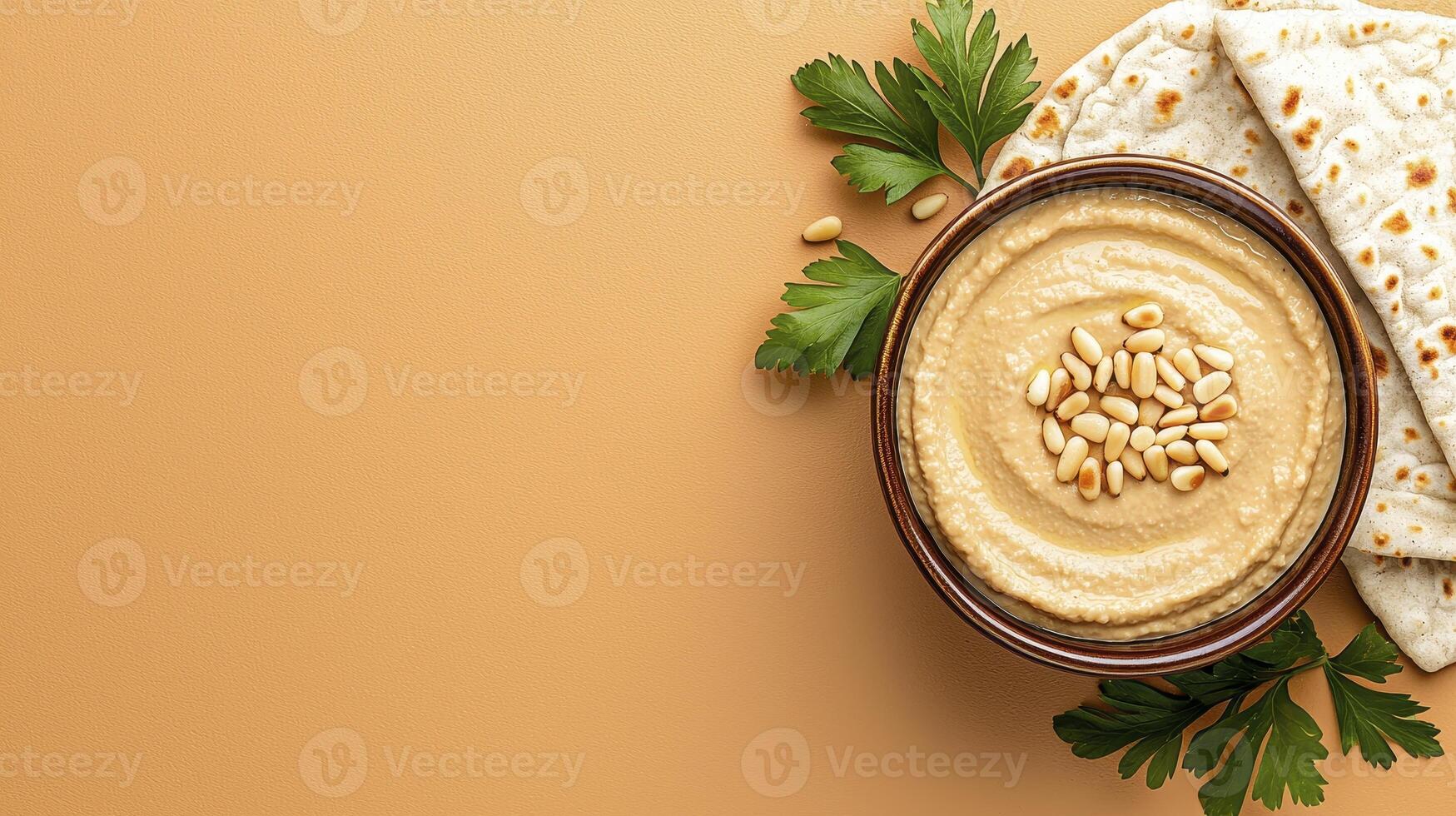 Delicious Homemade Hummus in a Rustic Bowl, Topped with Pine Nuts and Fresh Parsley, Displayed on a Neutral Beige Background with Pita Bread This vibrant food photograph captures the creamy texture photo