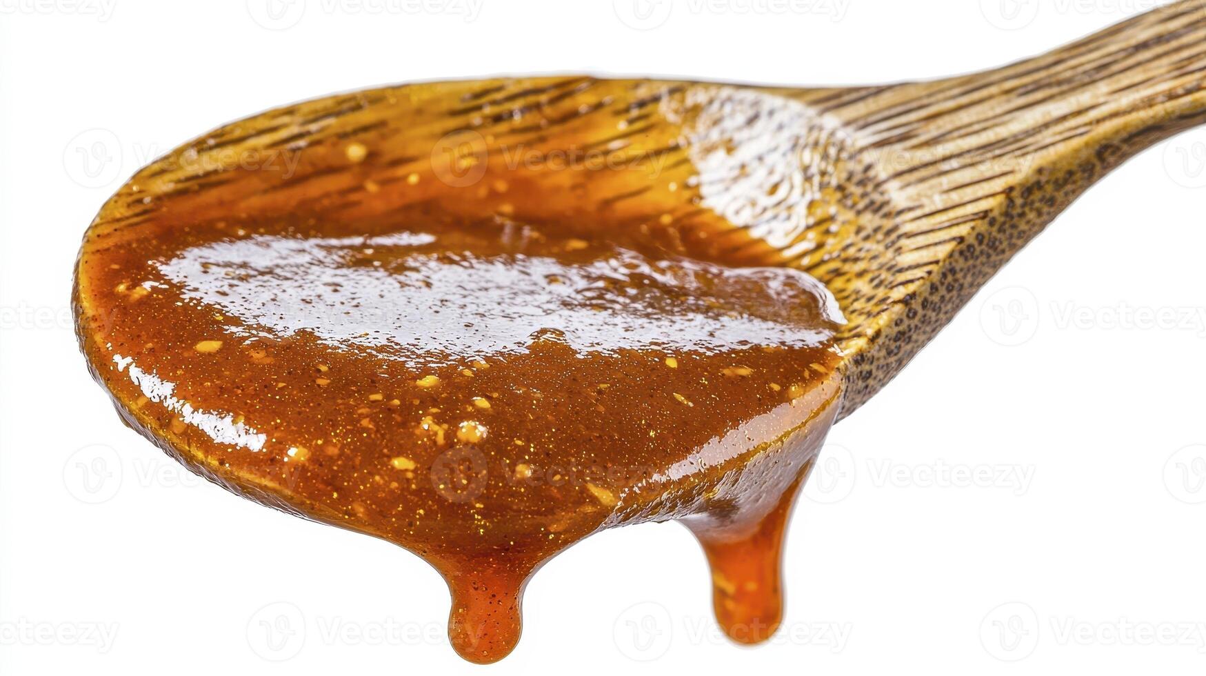 Captivating close-up shot showcasing a wooden spoon generously filled with a luscious, amber-hued caramel sauce, its rich texture and irresistible sweetness practically dripping off the edge, a photo
