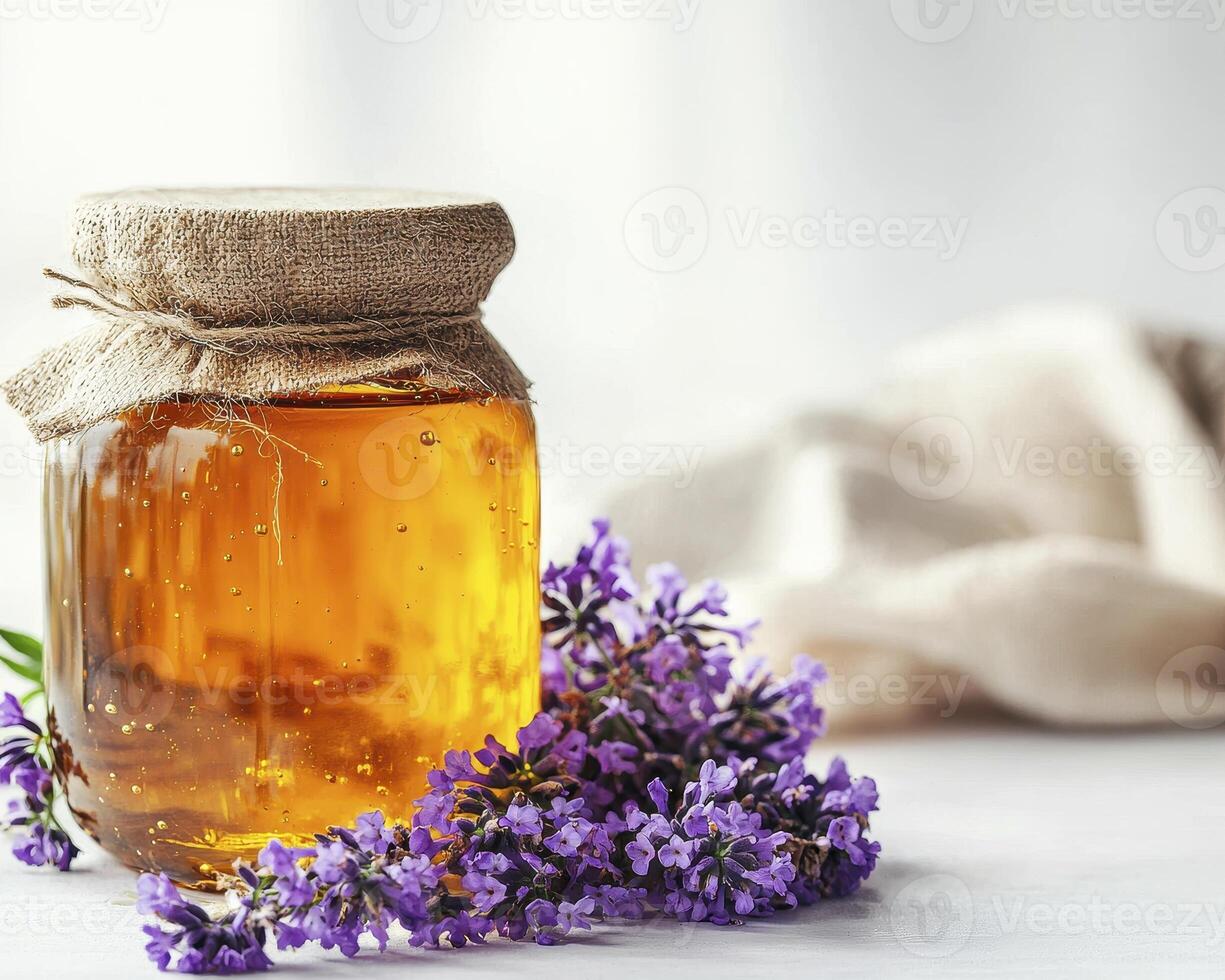 Discover the Golden Elixir A Close-Up of Natural Honey in a Glass Jar Adorned with Fresh Lavender Flowers, Symbolizing Health, Wellness, and the Sweetness of Life Explore the Rich Texture and Vibrant photo