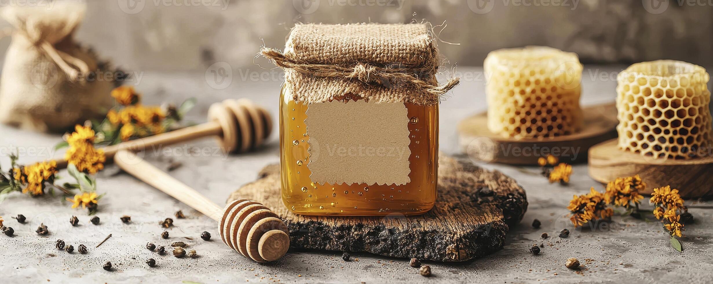 Golden Honey Jar Displayed with Honeycomb, Dippers, and Flowers A Sweet and Natural Composition Featuring a Glass Jar Filled with Pure Honey, Accompanied by Honeycomb Pieces on Wooden Boards and photo