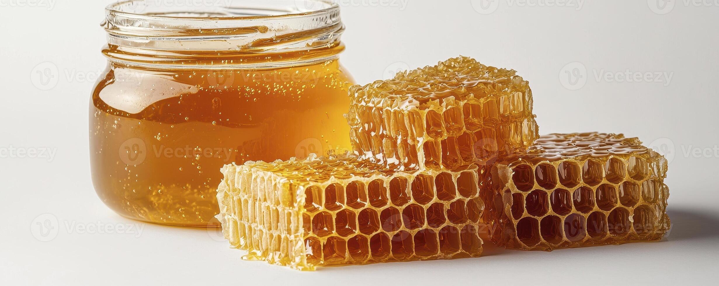 Golden Honeycomb and Jar of Honey A Natural Sweet Treat, perfect for breakfast or a healthy snack This image shows the beauty of nature's nectar, with golden hues and intricate honeycomb structures photo