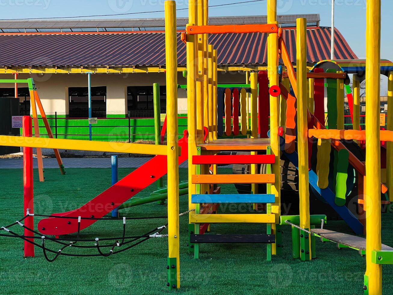 Colorful outdoor playground structures in a sunny park environment photo