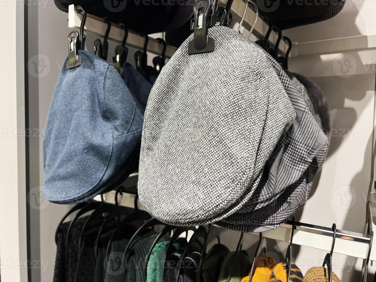 Close-up of stylish flat caps displayed on a retail store shelf photo