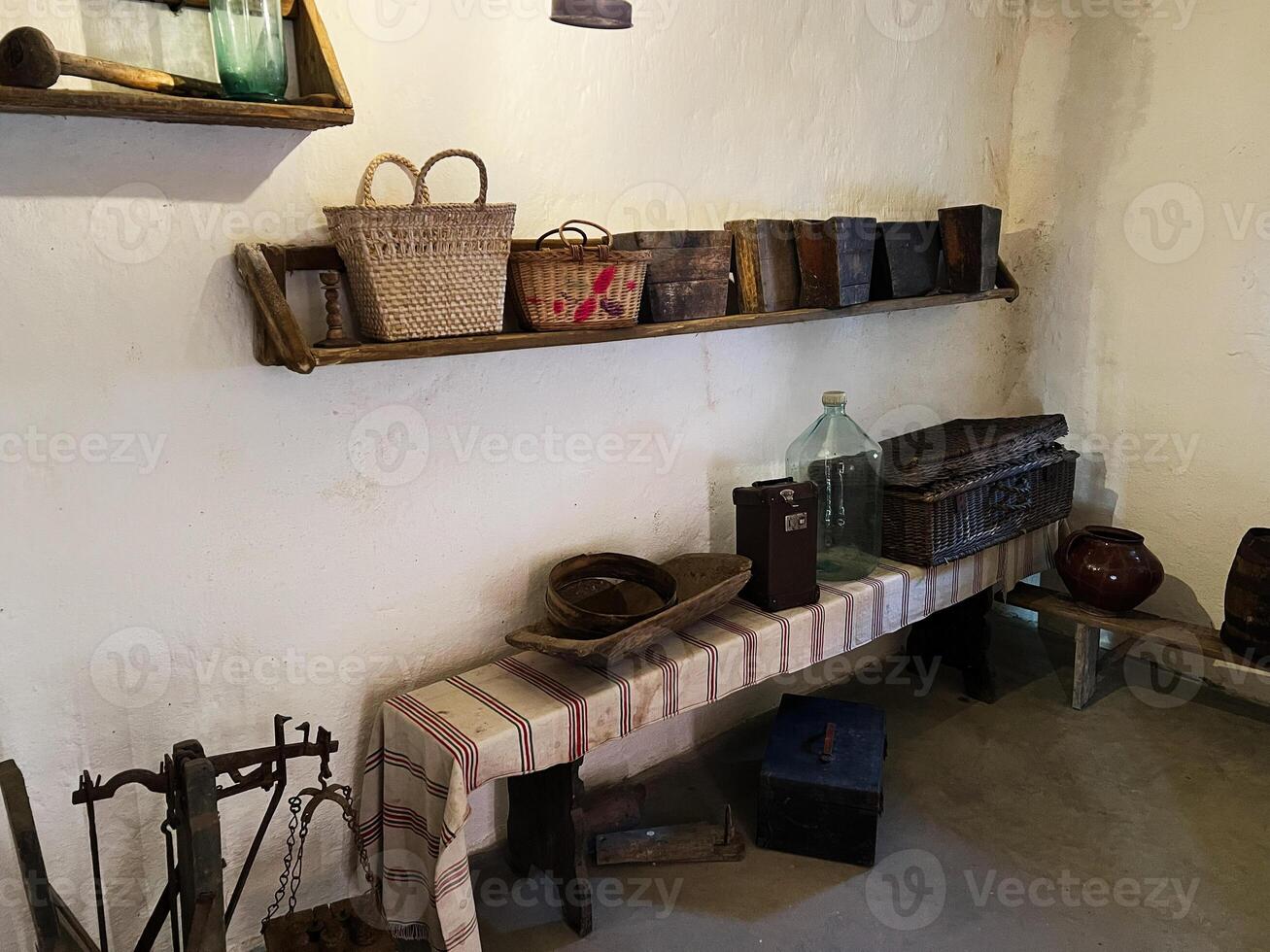 Vintage household items and storage on rustic shelves in a traditional kitchen photo