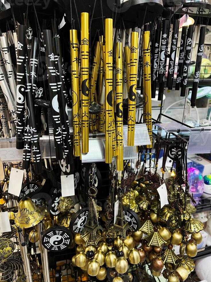 Colorful Feng Shui Bells and Chimes Displayed in a Store Setting photo