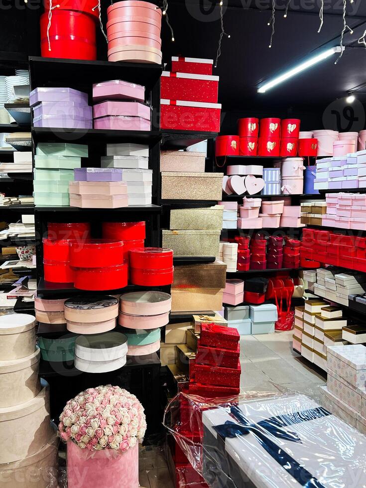 Shelves of colorful gift boxes and containers arranged neatly in a shop. photo