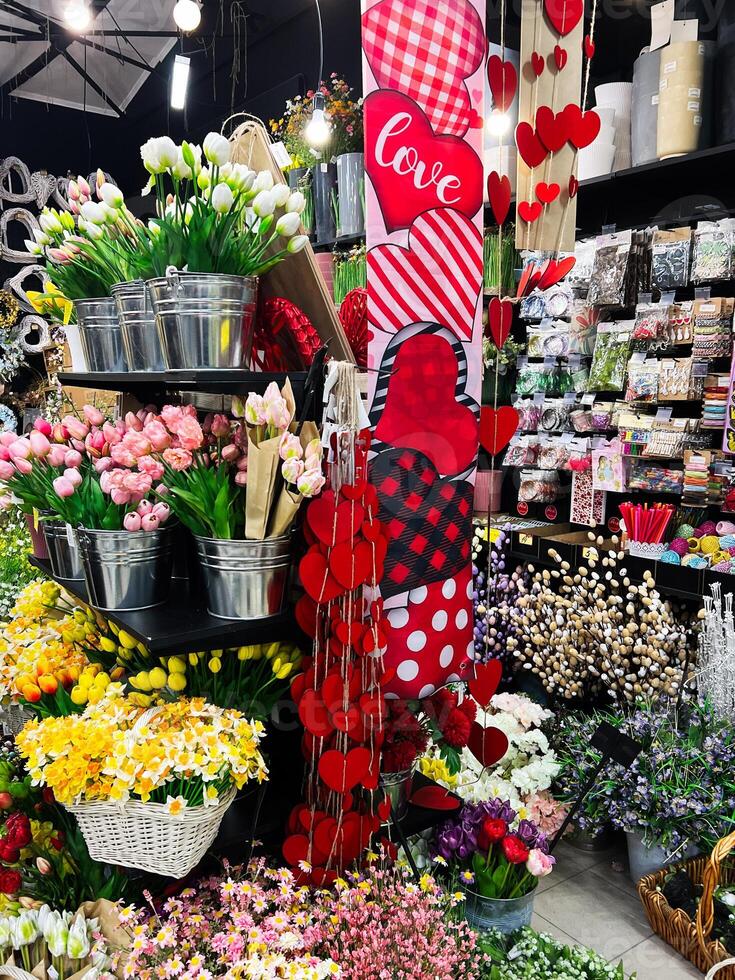 Decorative store with colorful flowers and Valentine's Day heart decorations photo