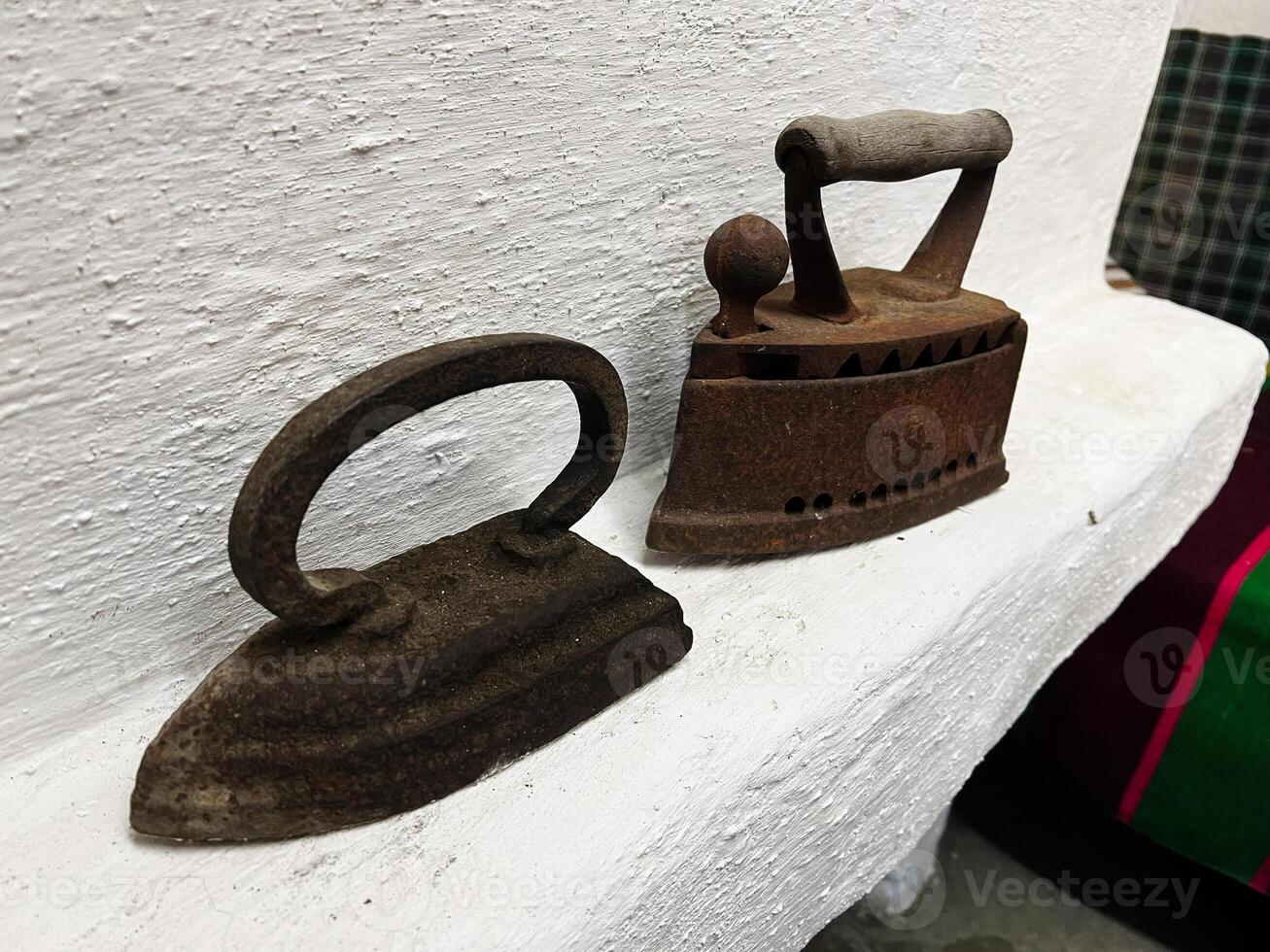 Vintage rustic flatirons showcased on a white surface in a homely environment photo