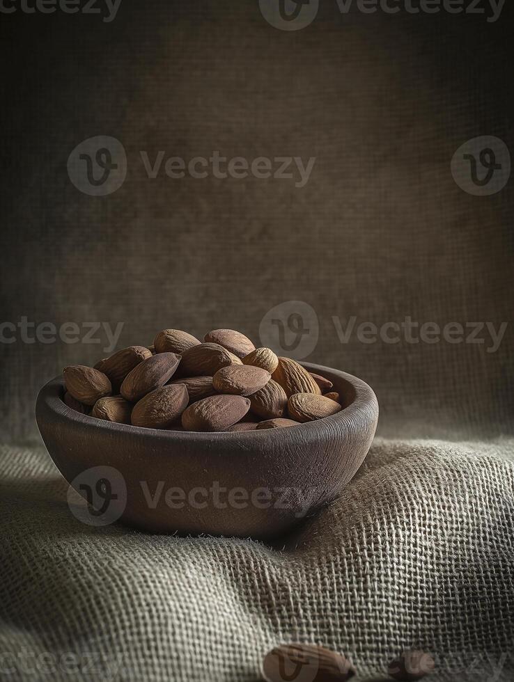a wooden bowl filled with almonds on burlap background creates rustic and inviting atmosphere photo
