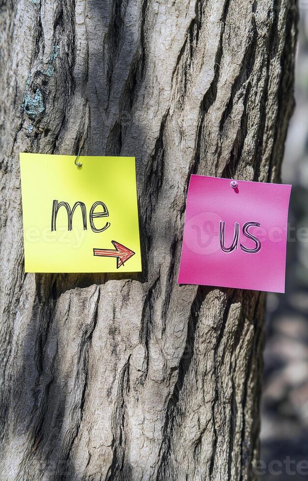 Two sticky notes on tree, one yellow with me and one pink with us, symbolizing connection photo