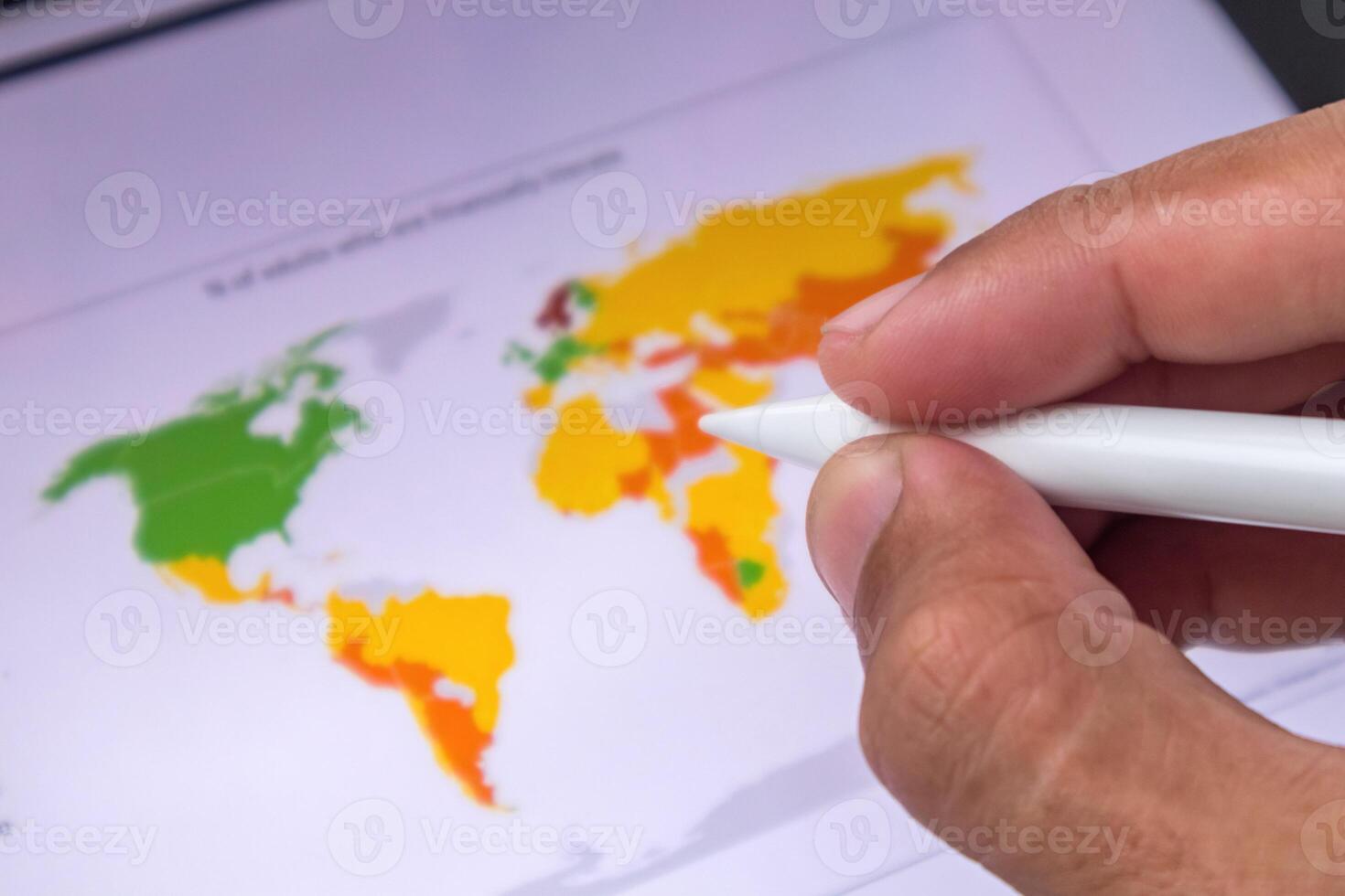 Businessman holding a pen pointing to global business world map on digital screen. Digital marketing or global network concept. photo
