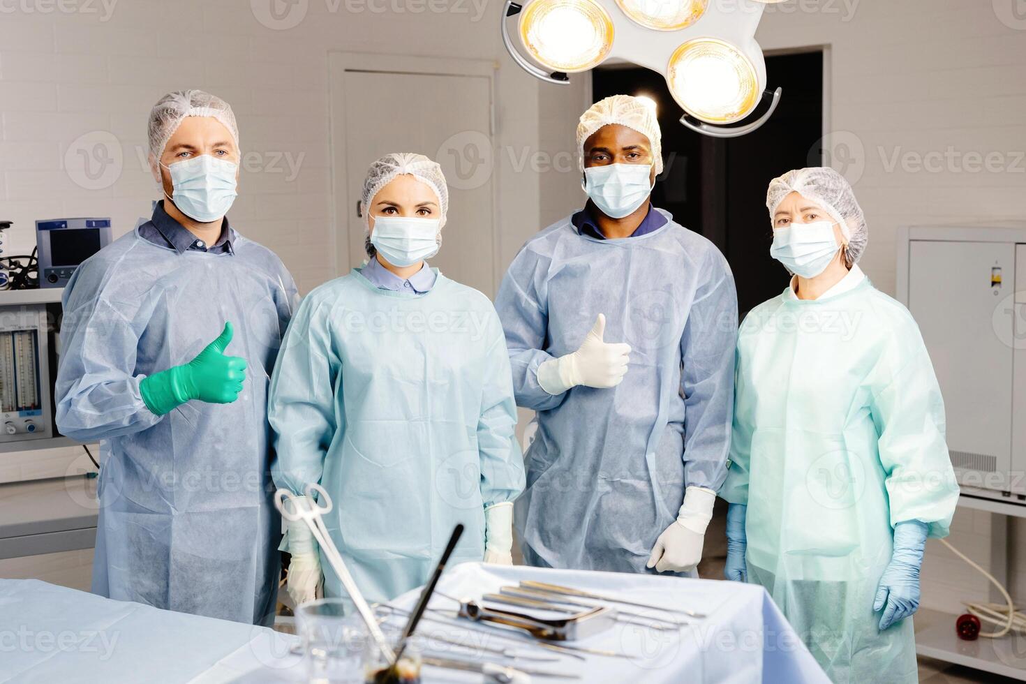 Group of doctors discussing patient cases around table in clinic photo