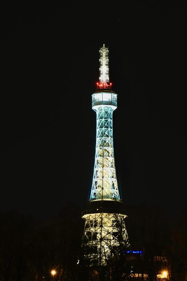 Illuminated Petrin tower during winter night in Prague Czechia in February 2025 photo
