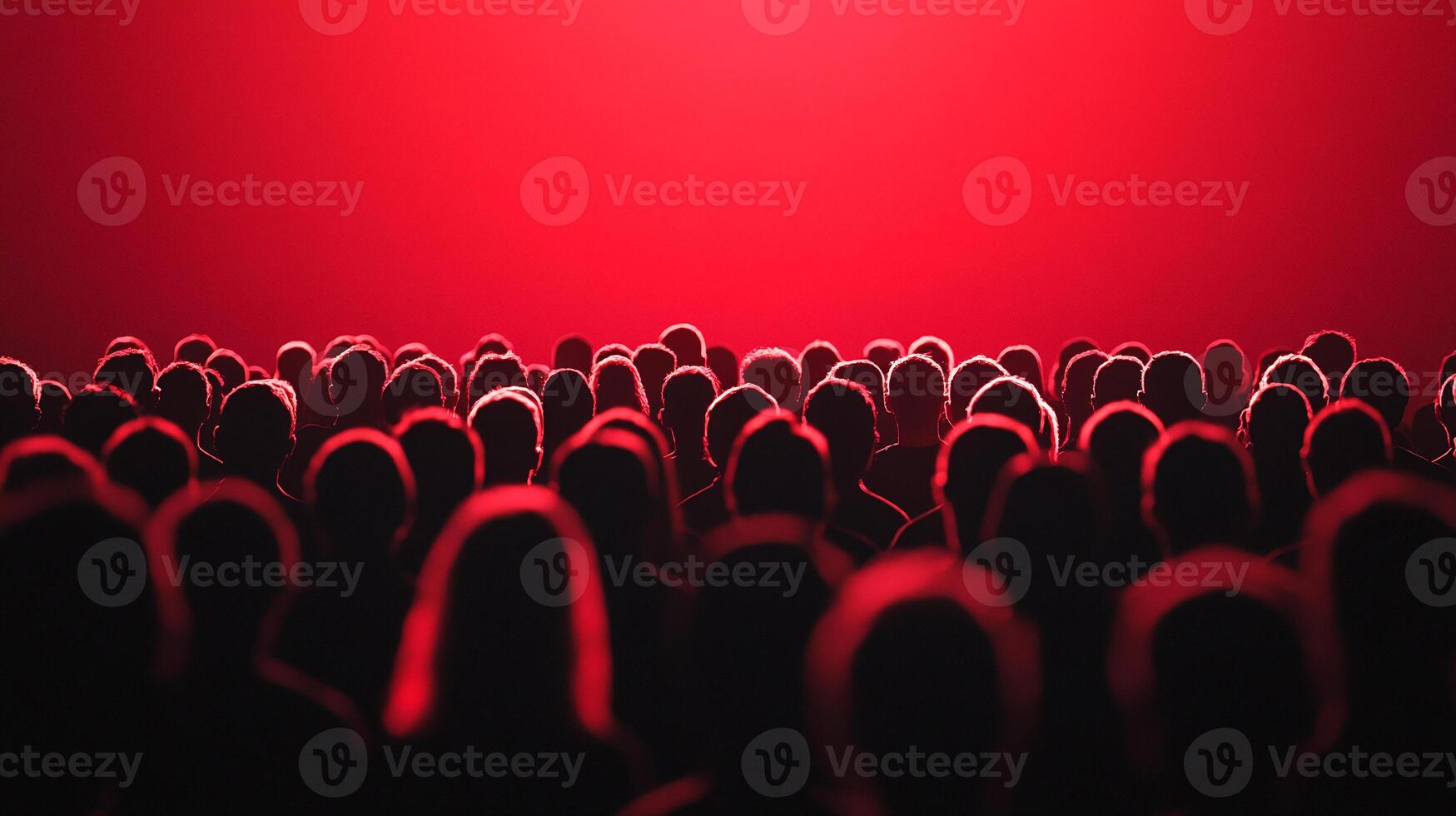 A crowd of people in front of a red light photo