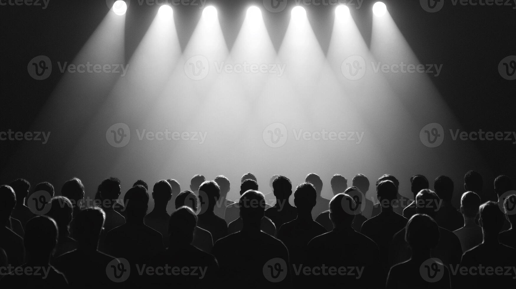 A crowd of people in front of a spotlight photo