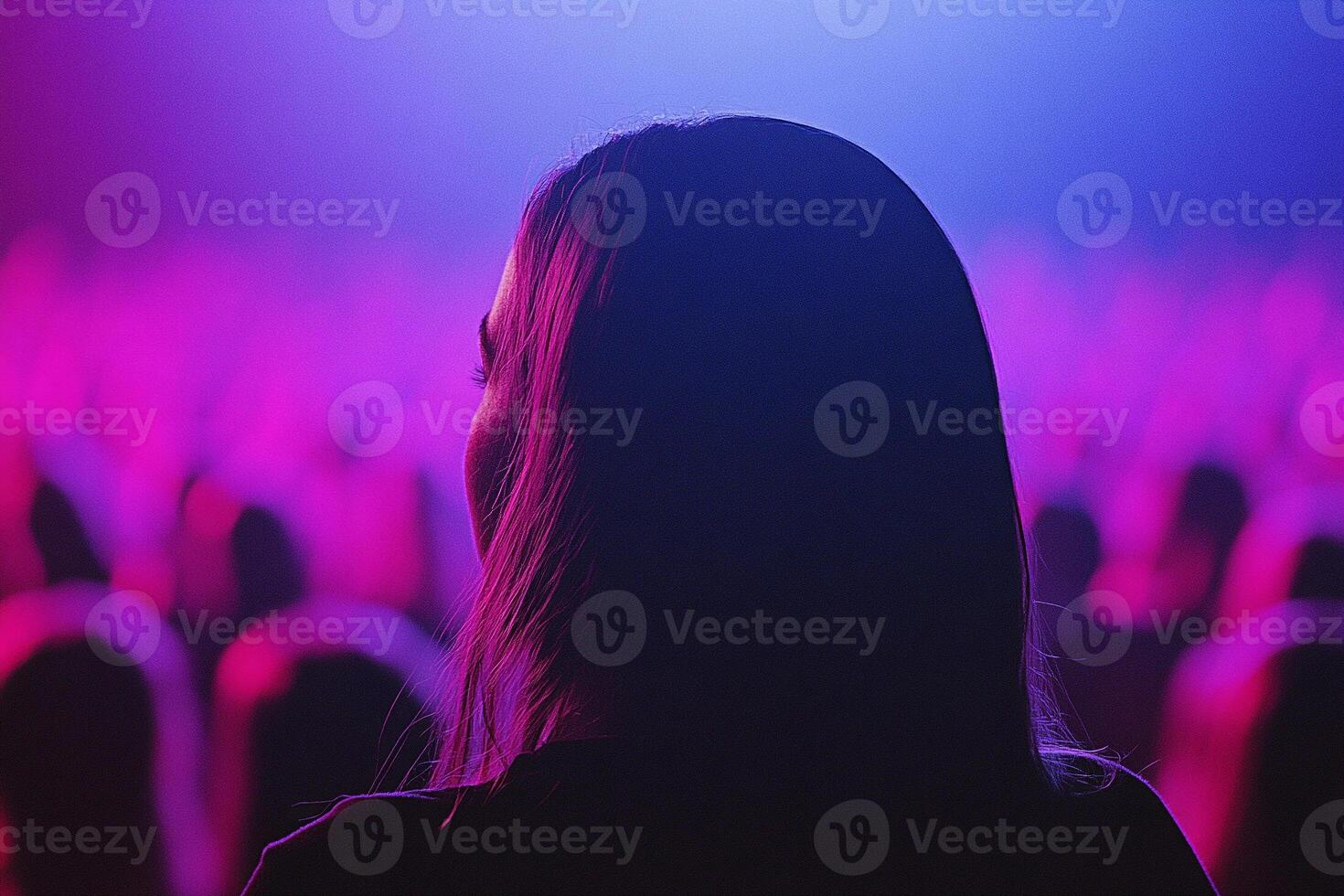 A woman is standing in front of a crowd of people photo