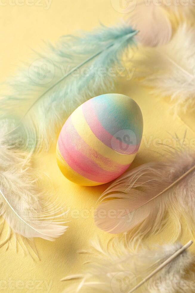 A unique colored egg nestled in a bed of bird feathers. photo