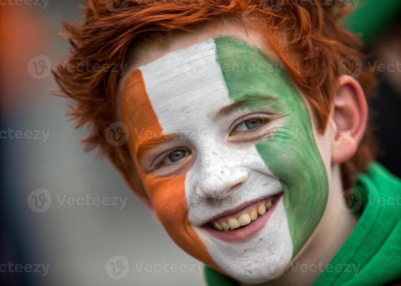 A cheerful red-haired boy with the Irish flag painted on his face, celebrating. photo