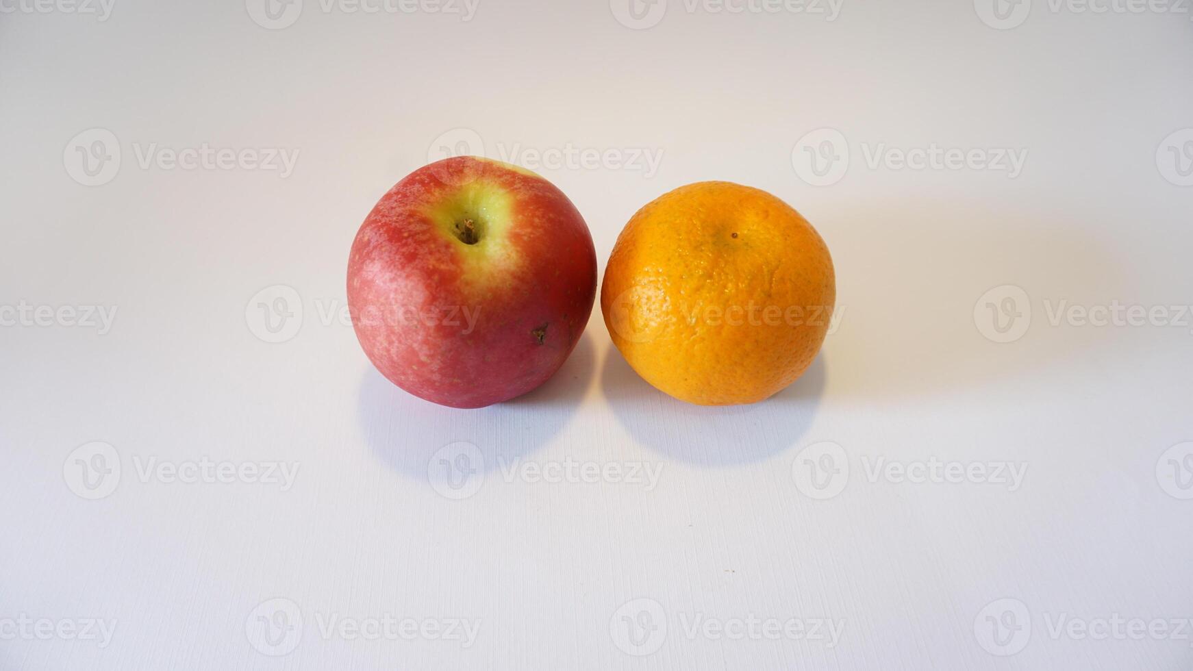 A red apple and an orange photo