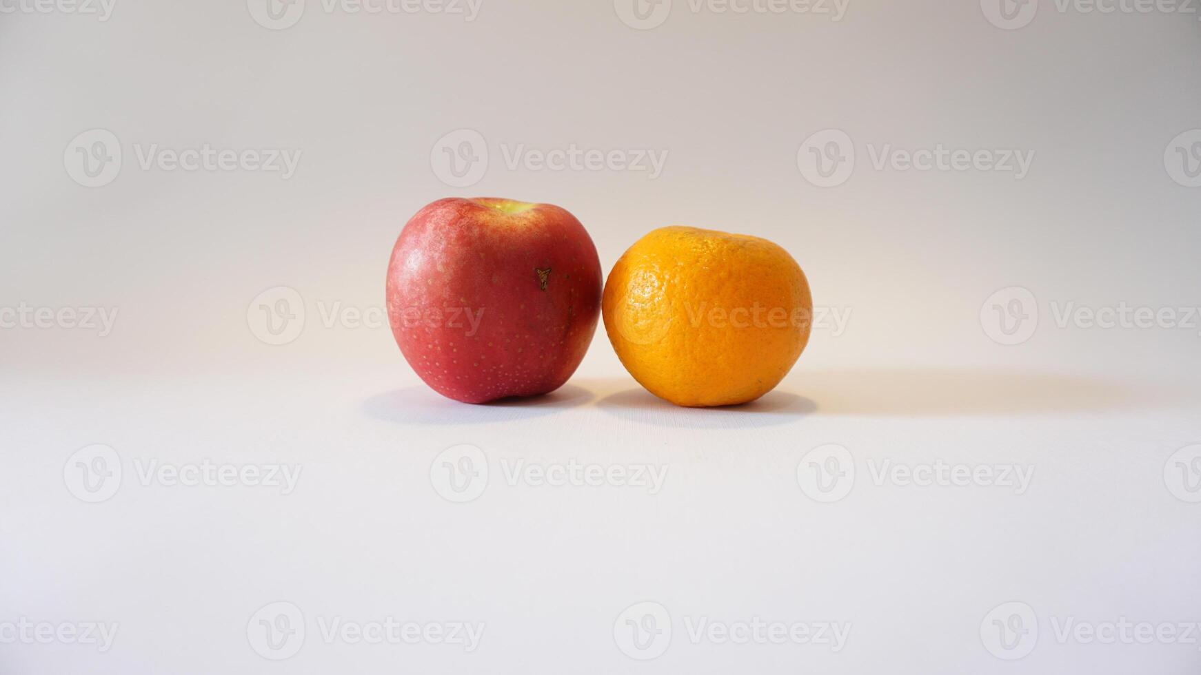 A red apple and an orange photo