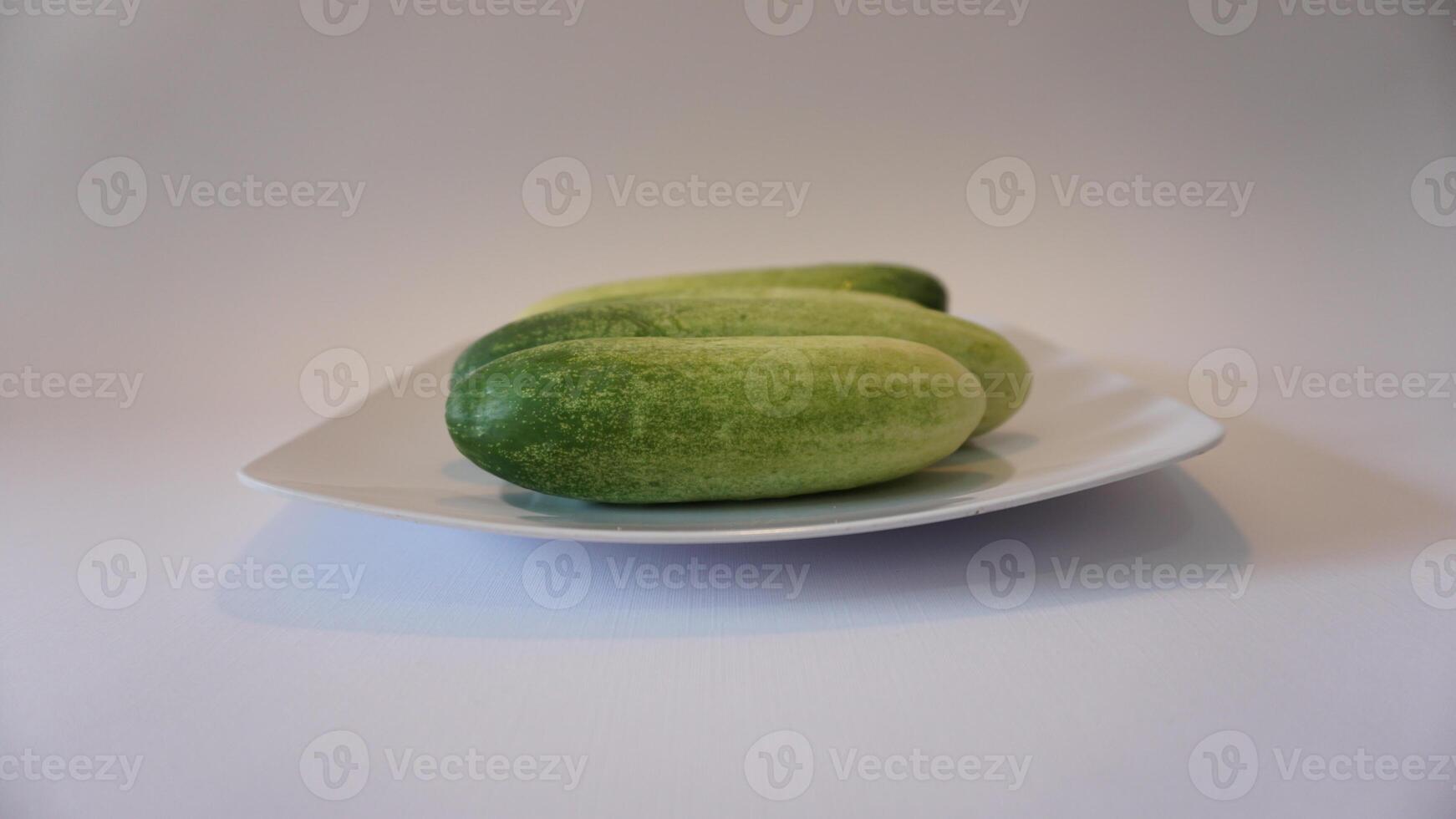 Three cucumbers on a plate photo