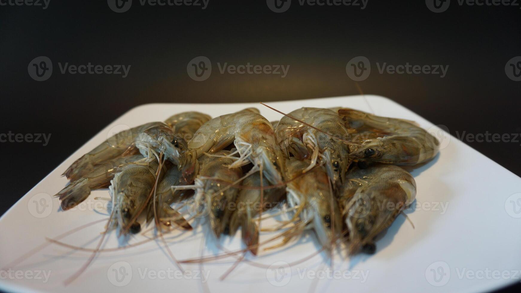 A plate of shrimp on a black table photo